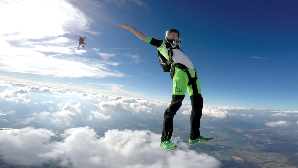 Experienced skydiver spreading arms and legs during free fall