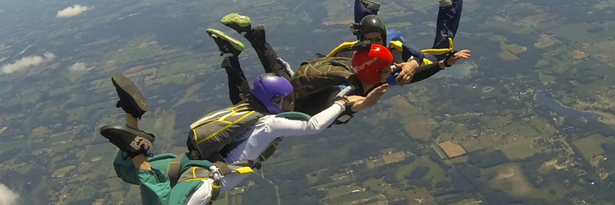 skydivers holding each others arms