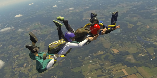 skydivers holding each others arms