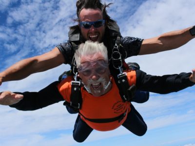 Tandem skydivers with the wind blowing in their faces