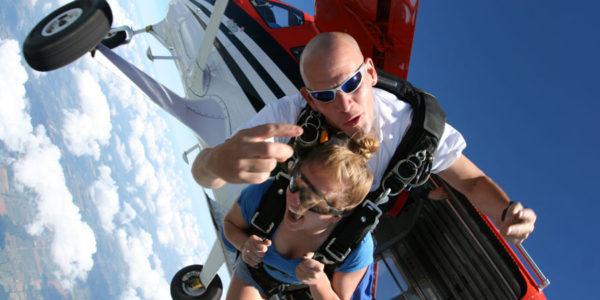 Tandem skydivers jump out of a plane with Skydive Tecumseh