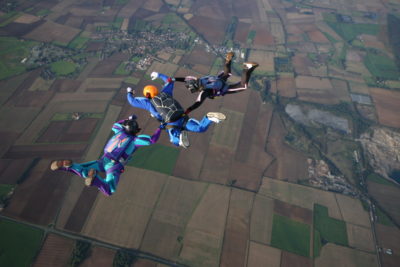 Three skydivers making a formation during free fall