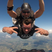 Tandem skydiving student looking stoked