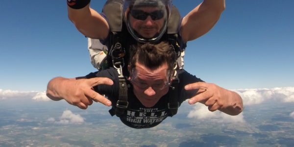 Tandem skydiving student looking stoked