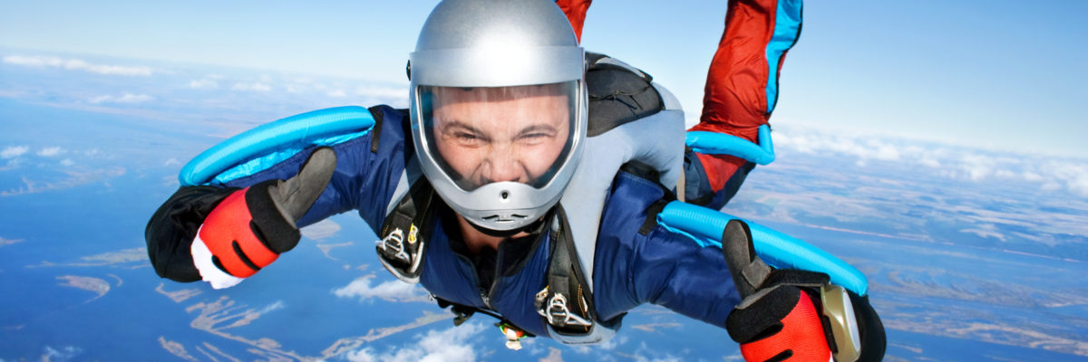 Skydiver falls through the air and gives two thumbs up