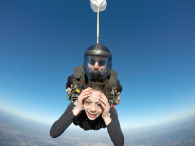 Tandem skydiving student with a worried look on her face