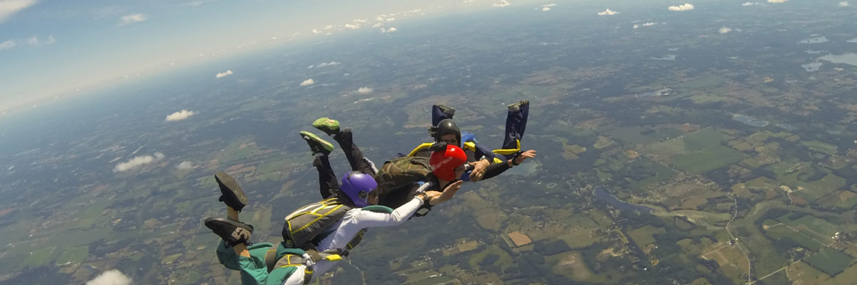 Skydivers holding hands during free fall