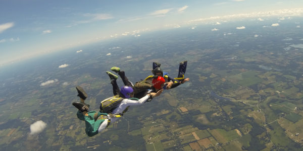 Skydivers holding hands during free fall