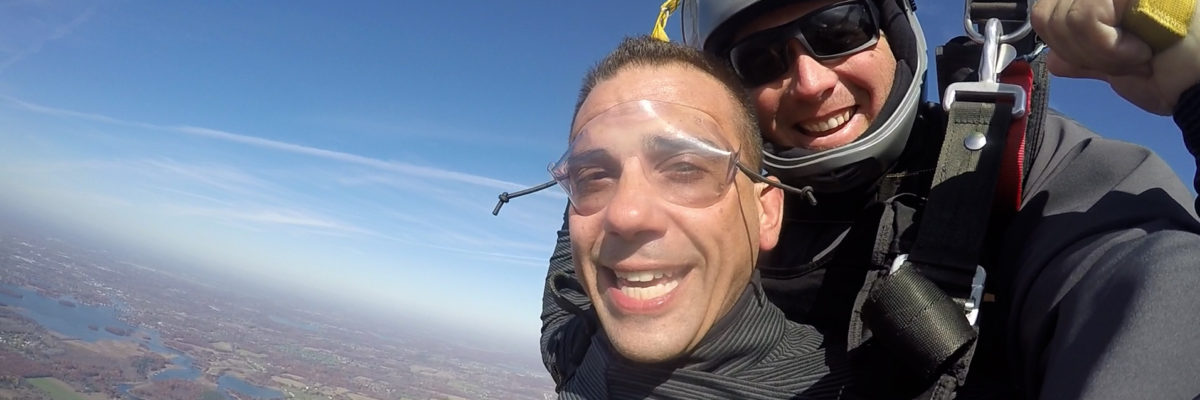 Tandem skydivers smiling during their parachute ride