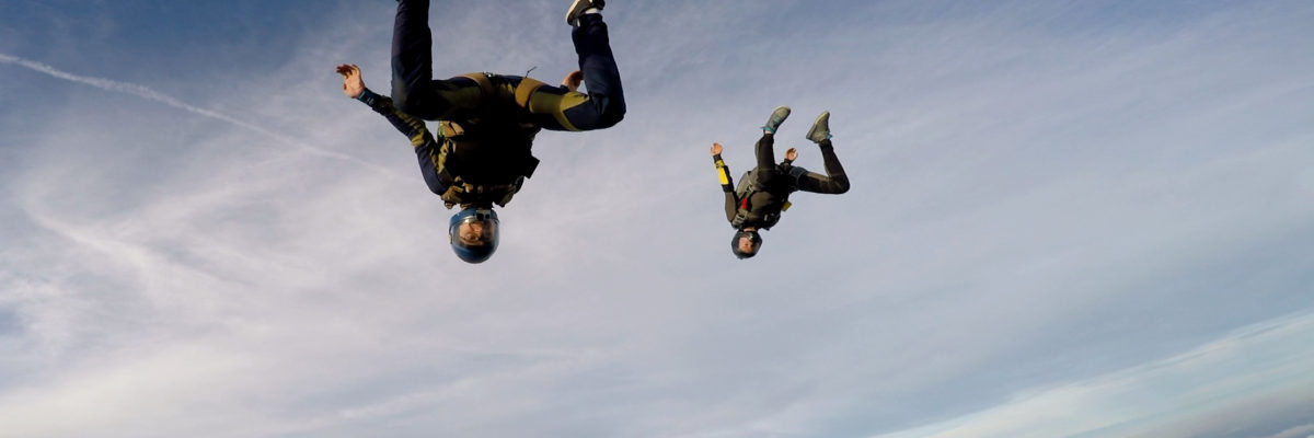 Pro skydivers free falling upside down