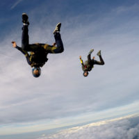 Pro skydivers free falling upside down