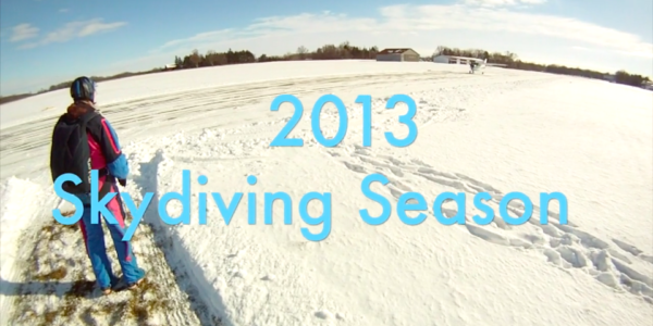 Skydiver standing in a field of snow