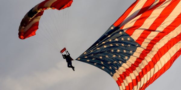 a skydiver towing the US Flag